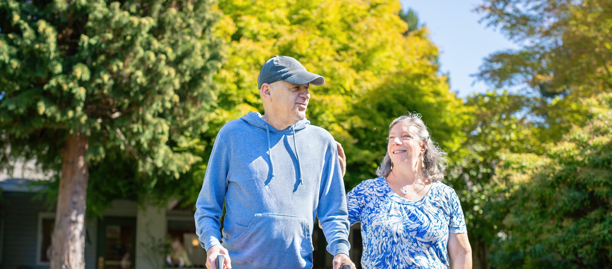 Resident walking outdoors with a team member at The Village at Broadview in Seattle, Washington